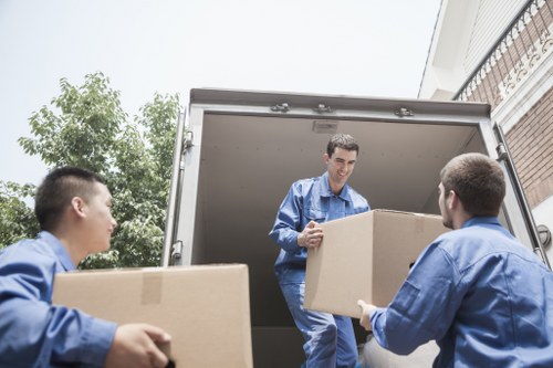 Movers carrying boxes during a same day relocation in Stockwell