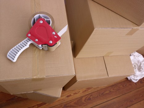 Packed boxes and wrapped furniture prepared for transport in a Stockwell removal van